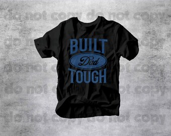 May include: Black t-shirt with the words "BUILT Dad TOUGH" in blue lettering. The text is arranged in a stacked format, with "Dad" inside a blue oval. The shirt has short sleeves and a crew neck.