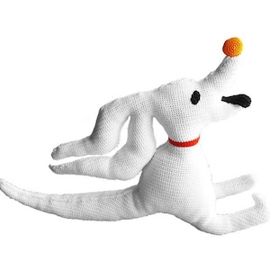 May include: White crocheted plush toy dog with a red collar and orange nose. The dog is in a running pose with its legs outstretched.