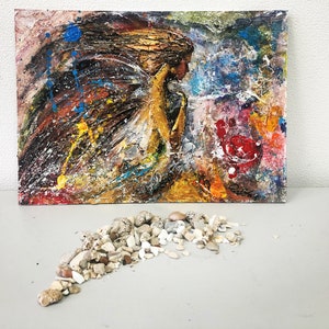 May include: Abstract painting on canvas with a textured surface. The painting features a figure with flowing hair and a colorful background with splashes of blue, yellow, red, and white paint.