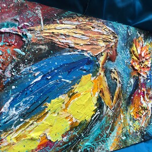 May include: Abstract painting of a woman with flowing blonde hair, wearing a blue and yellow dress, with a flower in the background. The painting is done in a textured style with thick layers of paint.