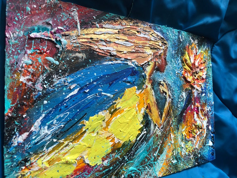 May include: Abstract painting of a woman with flowing blonde hair, wearing a blue and yellow dress, with a flower in the background. The painting is done in a textured style with thick layers of paint.