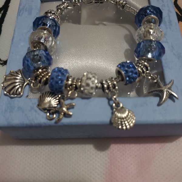 Great Gift for any occasion- Gorgeous blue, white & silver bracelet with seashell and starfish charms. Beautiful ocean, style charm bracelet