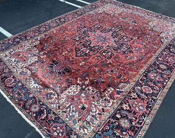May include: A large, intricately patterned rug with a red, blue, and white color scheme. The rug has a central medallion and a border with repeating motifs.