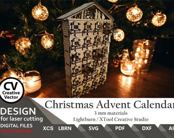 May include: A laser-cut wooden Christmas advent calendar featuring a multi-storey building design with numerous small drawers, a peaked roof, and a nativity scene silhouette at the top, designed for 3 mm materials and compatible with Lightburn and XTool.