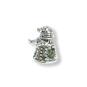 May include: Silver charm in the shape of a Dalek, a fictional robot from the British science fiction television series Doctor Who.