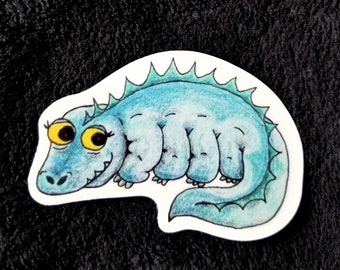 May include: A blue and green cartoon illustration of a segmented worm with a toothy grin and large yellow eyes. The worm is curled up in a sleeping position.