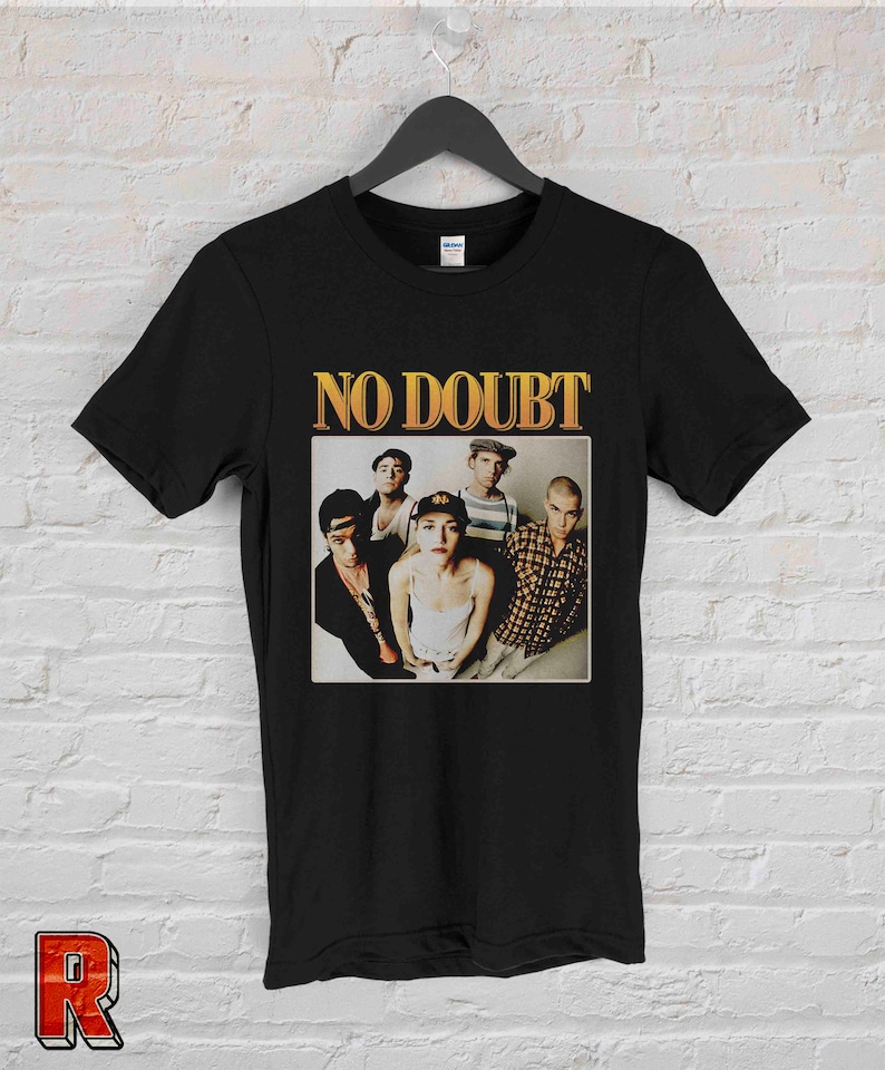 May include: Black t-shirt with a yellow graphic of the band No Doubt. The graphic features a photo of the band members, including Gwen Stefani.