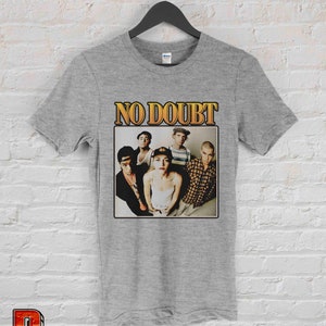 May include: Gray t-shirt with a vintage-style graphic of the band No Doubt. The graphic features a photo of the band members, including Gwen Stefani, in a black and white photo.