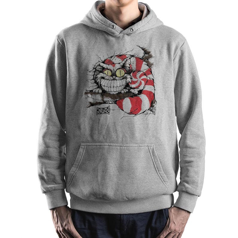 May include: A gray hooded sweatshirt featuring a graphic of the Cheshire Cat from Alice in Wonderland. The cat is smiling with red and white stripes. The sweatshirt has a front pocket and a drawstring hood.