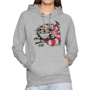 May include: A light gray hoodie featuring a graphic of the Cheshire Cat from Alice in Wonderland. The cat is depicted with a wide grin, striped tail, and red and white stripes. The hoodie has a drawstring hood and a kangaroo pocket.