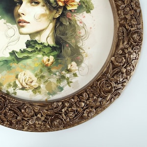 May include: A round framed painting of a woman wearing a white hat with flowers in her hair. The background is a watercolor style with flowers and greenery.