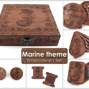 May include: Wooden embroidery set with a nautical theme. The set includes a box, a needle case, two thread bobbins, and a thread winder. The box is decorated with a seahorse and other marine life.