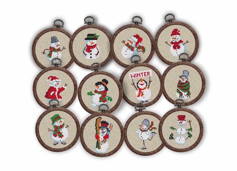 May include: A collection of twelve circular cross-stitch ornaments, each featuring a unique snowman design. The snowmen wear hats, scarves, and other winter accessories. The ornaments are framed in wooden hoops with a metal loop for hanging.