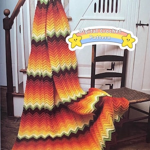 May include: A colourful crochet blanket in shades of orange, yellow, green, and brown, draped over a wooden chair. The blanket features a chevron pattern and is made with a soft yarn. The image includes the text "Digital Crochet Pattern".