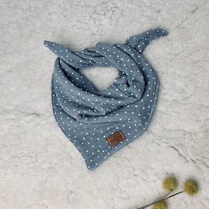 May include: A blue and white polka dot bandana with a brown leather tag that says "moitie".