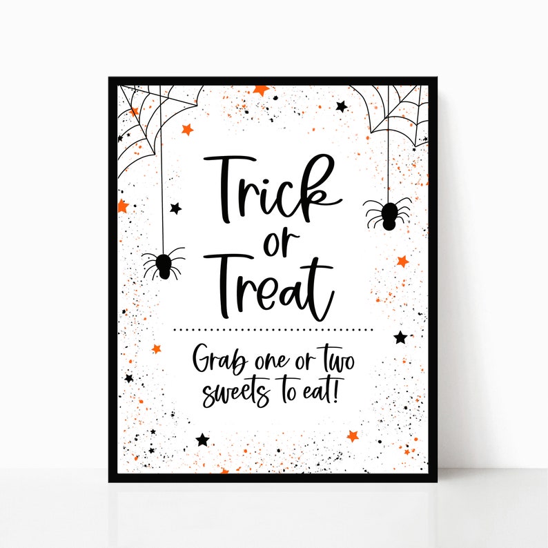 May include: A white printable sign with black text that says "Trick or Treat" and "Grab one or two sweets to eat!" The sign is decorated with black spiderwebs, orange stars, and black spiders.