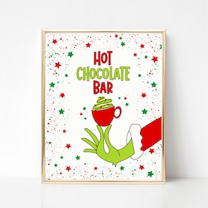 May include: A printable sign with a green hand holding a red mug with a green whipped cream topping. The sign says "Hot Chocolate Bar" with red and green stars in the background.