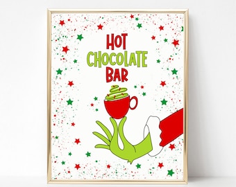 May include: A printable sign with a green hand holding a red mug with a green whipped cream topping. The sign says "Hot Chocolate Bar" with red and green stars in the background.