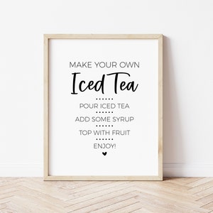 May include: A printable sign with the text "MAKE YOUR OWN Iced Tea" and instructions to pour iced tea, add some syrup, top with fruit, and enjoy. The sign is framed in a light wood frame.