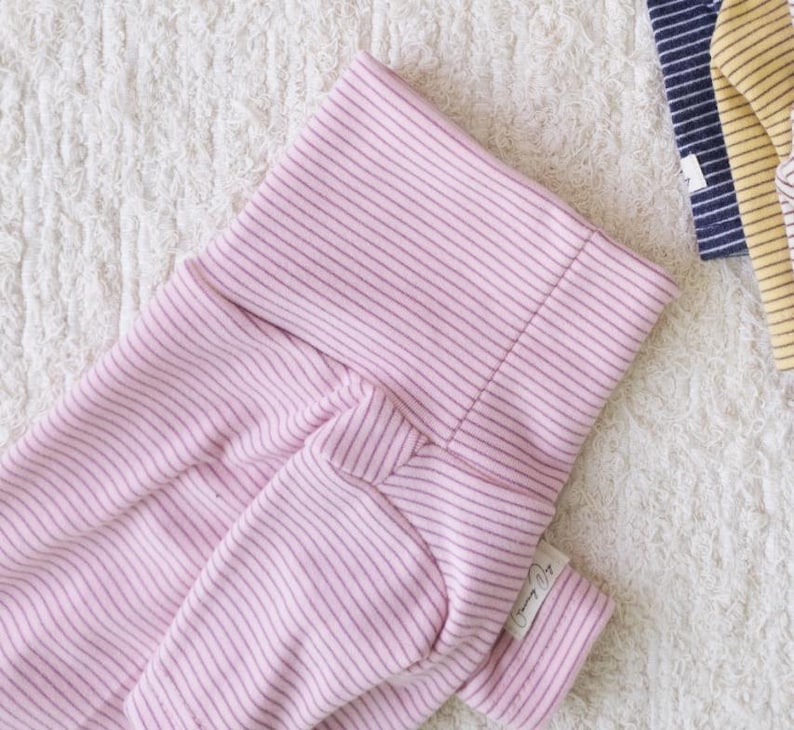May include: Pink striped baby onesie with a white tag that says "Mommy & Me".