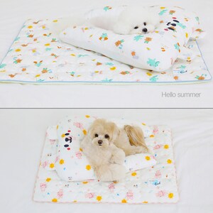 May include: Two images of a white dog sleeping on a white and green patterned pet bed with a matching pillow. The first image shows the dog sleeping on the pillow, and the second image shows the dog sleeping on the bed. The text "Hello summer" is below the first image, and the text "Sun rabbit" is below the second image.