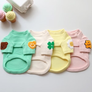 May include: A set of three ceramic mugs with a speckled, matte finish. The mugs are in shades of cream, light gray, and dark gray. Each mug has a simple, minimalist design, perfect for coffee or tea.