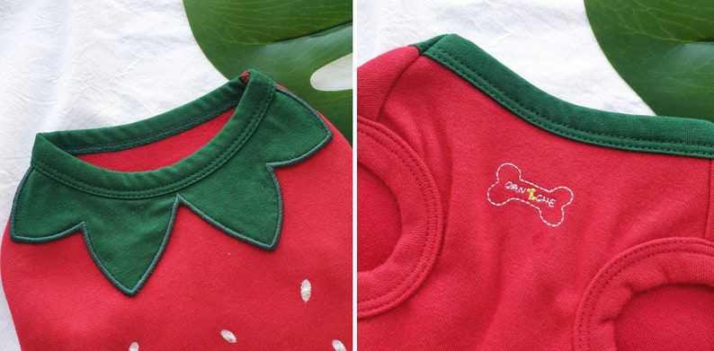 Pode incluir: Camiseta vermelha para cachorro com um design de morango verde e um osso branco com o texto "GRAWLICHE" nas costas.
