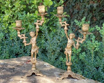 Pair of brass candlesticks, 2 two-armed cherubs / Capacity: 4 candles / Genuine pair / Candlesticks for stick candles / Vintage decoration