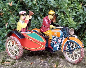 Reproduction of an old mechanical metal sidecar / Motorcycle, Tuf-Tuf / Wind-up mechanical toy with key / Collection of old games and toys