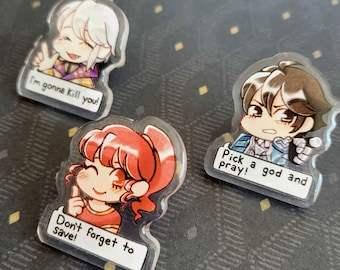 May include: Three clear acrylic charms with cartoon characters. One says "I'm gonna kill you!", another says "Don't forget to save!", and the last says "Pick a god and pray!". The characters have different hair colors and outfits.