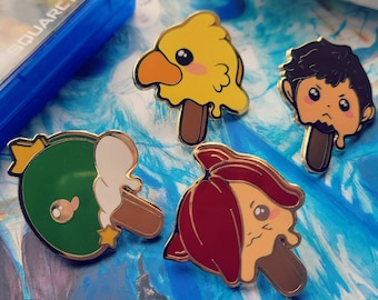 May include: Four enamel pins featuring cartoon characters on popsicle sticks. The characters are a yellow bird, a green duck, a red-haired girl, and a brown-haired boy. The pins are all gold-colored and have a shiny finish.