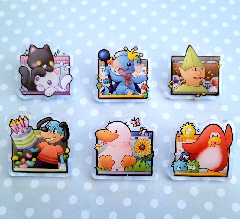 May include: Set of six clear acrylic pins featuring cartoon characters. Designs include a black cat and white cat, a blue elephant with a crown, a green elf, a dog with a cake, a pink duck, and a red penguin. Each pin has a unique background.