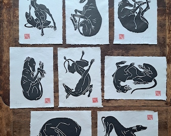 All 8 of my A4 size, hand printed, linocut longdogs, greyhounds, lurchers, whippets.