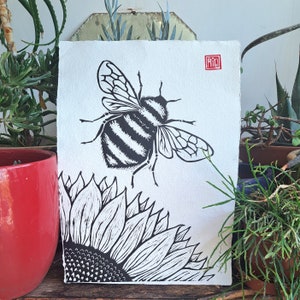 Believing. Original linocut print of a Bee and a Sunflower. A3 size 11.7 x 16.5 inches on handmade cotton rag paper.