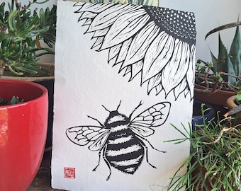 Becoming. Original linocut print of a Bee and a Sunflower. A3 size 11.7 x 16.5 inches on handmade cotton rag paper.