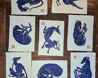 All 8 of my A4 size, hand printed, linocut longdogs, greyhounds, lurchers, whippets. Blue Edition
