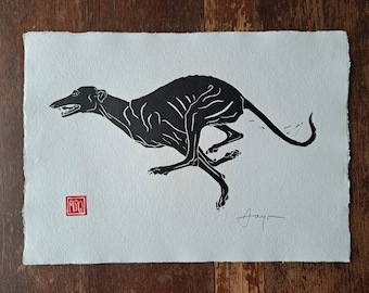 May include: Black and white print of a running greyhound dog. The print is signed "Ayao" in the bottom right corner and has a red stamp in the bottom left corner.
