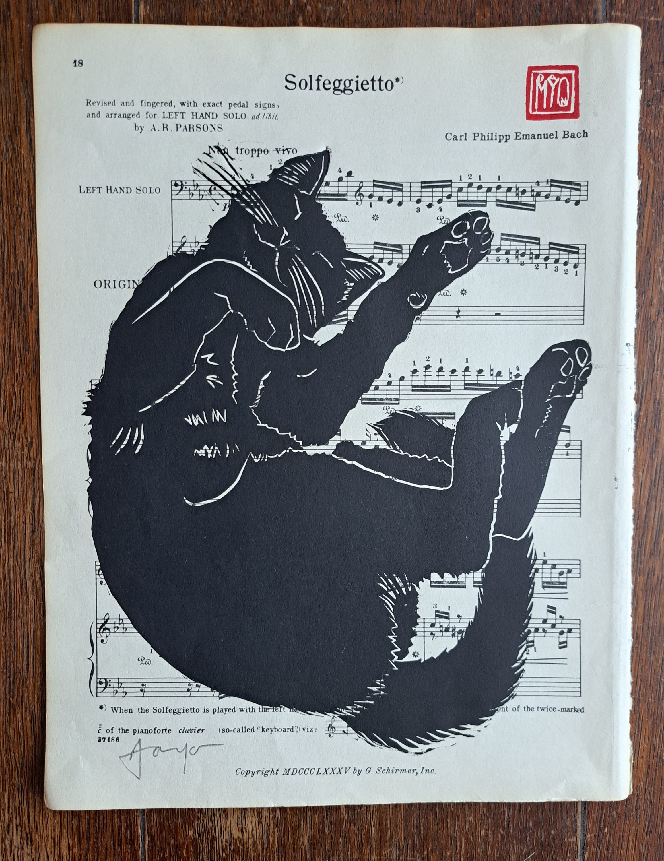 Special Edition Snoozing Black Cat. Gorgeous hand printed linocut of a cat dozing on a lazy morning. Printed on vintage sheet music.