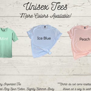 May include: Three unisex t-shirts in different colors: mint green, ice blue, and peach. The shirts are made of 100% combed ring spun cotton and have a slightly slimmer body. The text "Unisex Tees" and "More Colors Available!" is at the top of the image. The text "Mint", "Ice Blue", and "Peach" is printed on each shirt. The text "District Very Important Tee" and "100% Combed Ring Spun Cotton, Slightly Slimmer Body" is at the bottom of the image. The text "...Shirts do not come knotted. It is just shown as a way to wear the shirt..." is at the bottom right of the image.