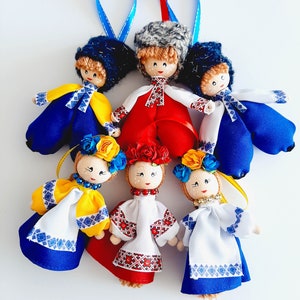 May include: A set of eight handmade dolls dressed in traditional Ukrainian clothing. The dolls are made of fabric and have embroidered details. They are all wearing colorful clothing and have different hairstyles.