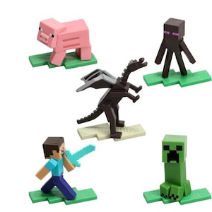 May include: A set of five Minecraft figurines, including a pink pig, a brown dragon, a green creeper, a black and purple Enderman, and a blue-shirted Steve figure. Each figure stands on a green base.