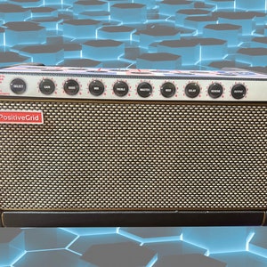 May include: A black and tan Positive Grid guitar amplifier with multiple control knobs and the brand name displayed. The amplifier has a speaker grill and a textured surface. The background is a blue geometric pattern.