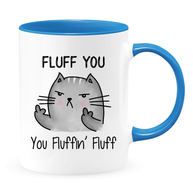 May include: White ceramic coffee mug with a blue rim and handle. The mug features a cartoon cat with a grumpy expression and the text "FLUFF YOU You Fluffin' Fluff".