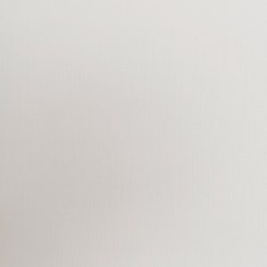 May include: A close-up of a white, textured fabric. The fabric has a subtle grid pattern, with vertical and horizontal lines creating a woven appearance. The color is a soft, off-white, providing a neutral background.