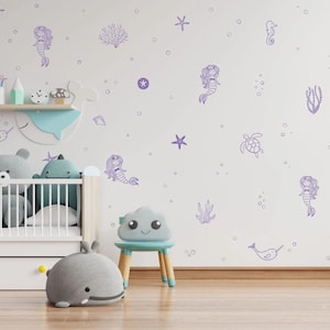 May include: A nursery room with a white wall decorated with purple mermaid, seahorse, turtle, starfish, and seaweed decals. The wall is labelled "Lavender".