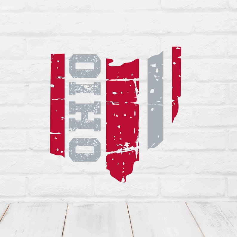 May include: A distressed graphic of the state of Ohio in red, gray, and white. The word "OHIO" is vertically stacked in gray, with red and gray stripes forming the state's shape. The design has a vintage, worn look.