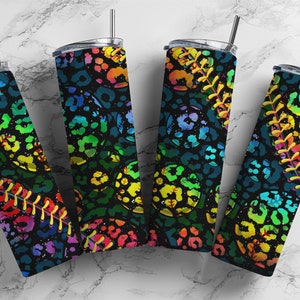 May include: Four stainless steel tumblers with lids and straws. The tumblers feature a black background with a colorful leopard print and baseball stitching design. The colors include rainbow hues of yellow, green, blue, and red.