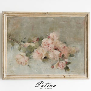 May include: A framed painting of a bouquet of pink roses with green leaves on a light blue background. The frame is a light wood color with a distressed finish.