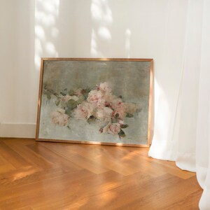 May include: A framed painting of a bouquet of pink roses in a vintage style. The painting is set against a light green background and has a wooden frame.