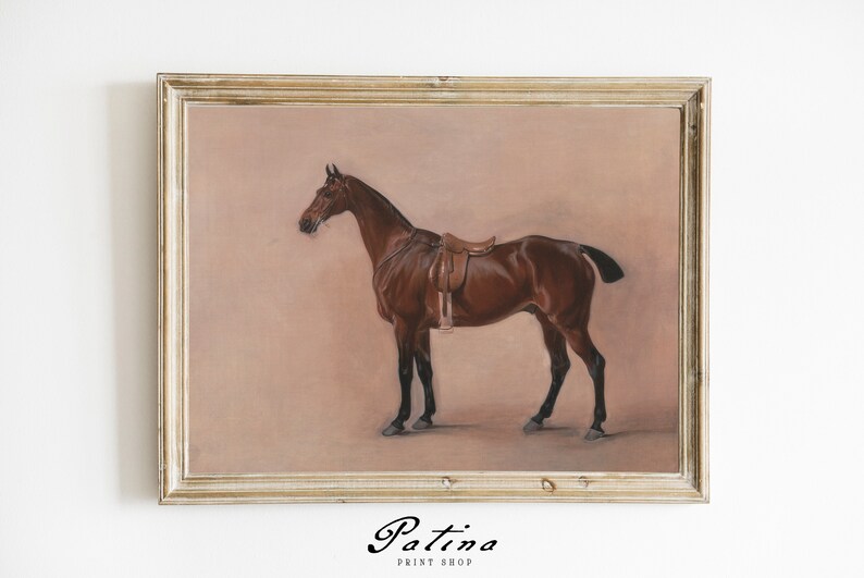 May include: A framed painting of a brown horse with a saddle, set against a light pink background.